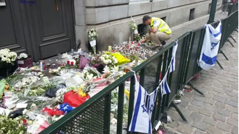 Man lays flowers at memorial outside Brussels