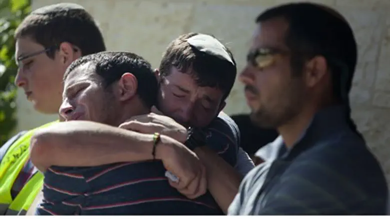Friends and relatives of Gilad Sha'ar comfort