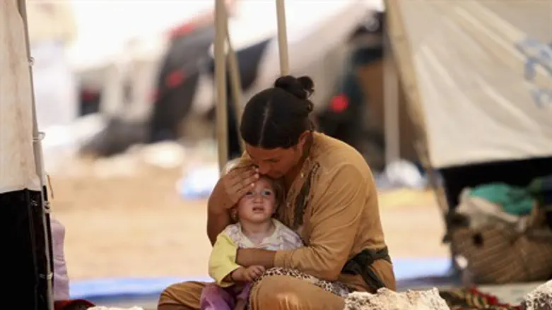 Yazidi woman with child (file)