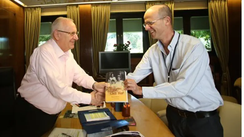 Hagai Segal presents a copy of the book to Is
