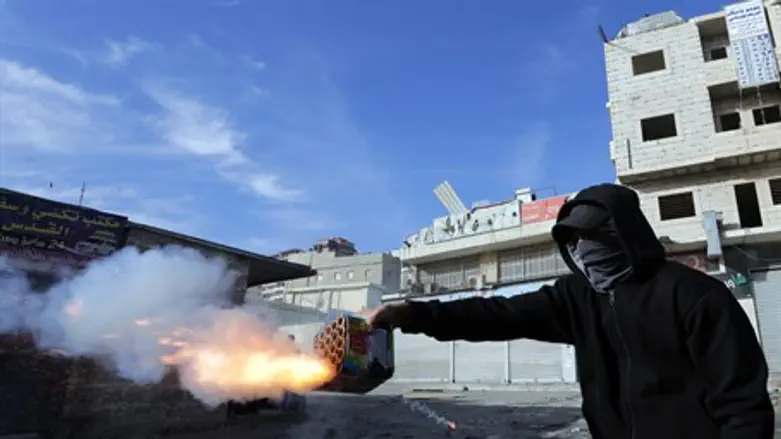 Arab rioter shoots fireworks at Israeli polic