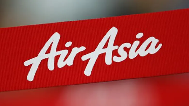 An AirAsia sign is pictured at its check-in counter at Changi Airport in Singapore