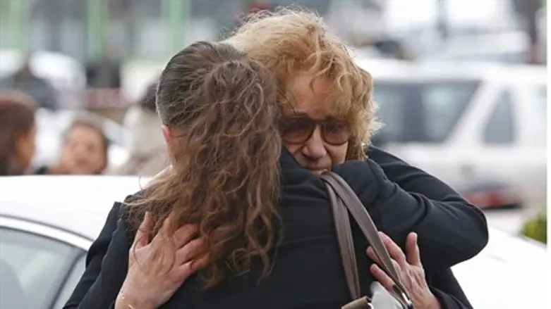 People react while paying tribute to victims of attack on Hyper Cacher store in Paris