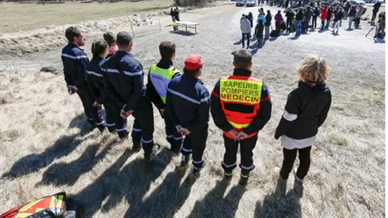 Rescuers stand by as relatives of Germanwings crash victims pay respects at memorial