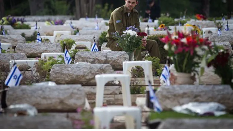 Soldier mourns at Mount Herzl military cemetery