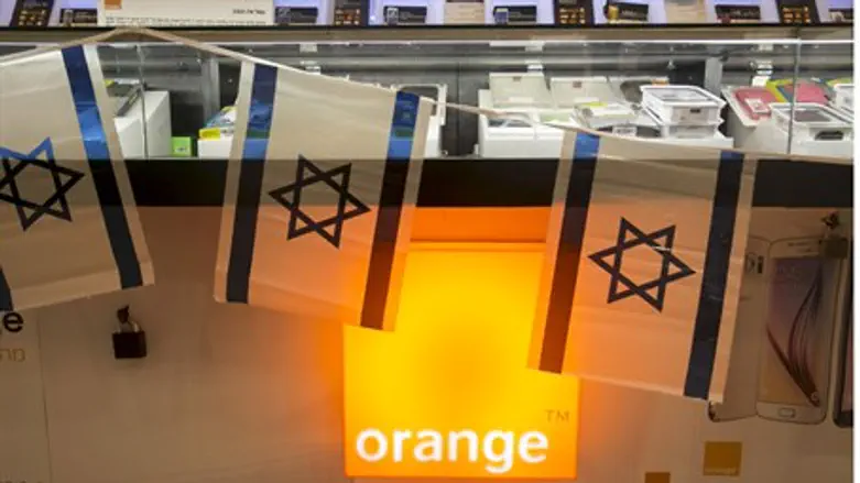 Israeli flags hang over the Orange logo