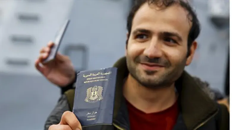 Syrian refugee holds passport