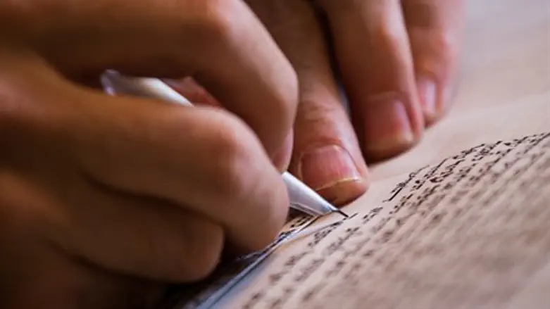 Scribe writes a Torah scroll (illustration)