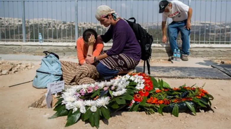 Israelis mourn at the graves of Rabbi Eitam and Naama Henkin, hy"d
