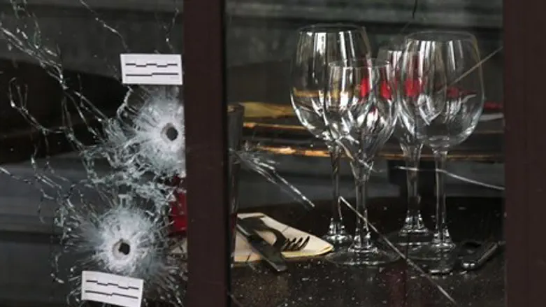 Bullet holes in the window of a restaurant targeted in Paris attack