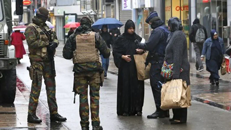 Belgian soldiers and armed police patrol central Brussels