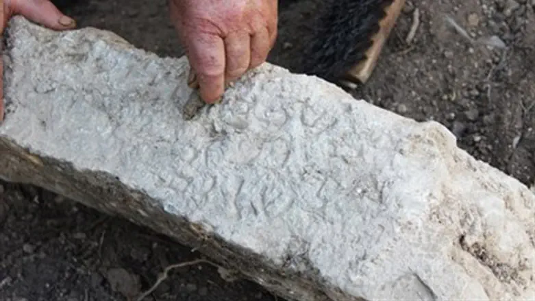 Cleaning one of the Aramaic inscriptions.