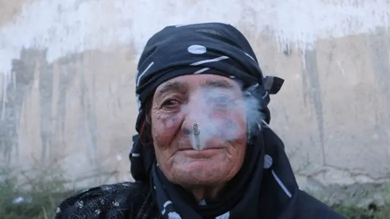 Woman smokes in Manbij.