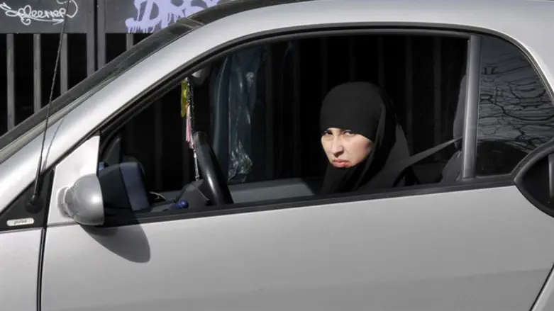 Muslim woman driving (illustration)