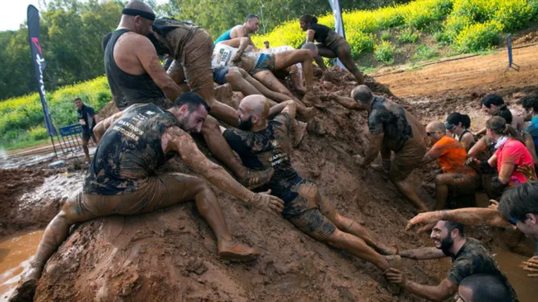 Participants take part the first Mud Day Israel obstacle course race in Tel Aviv