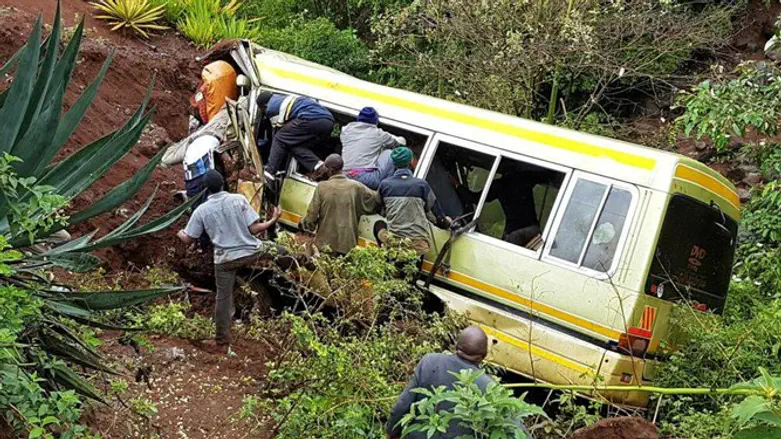 Rescue workers attempt to rescue victims of Tanzania bus creash.