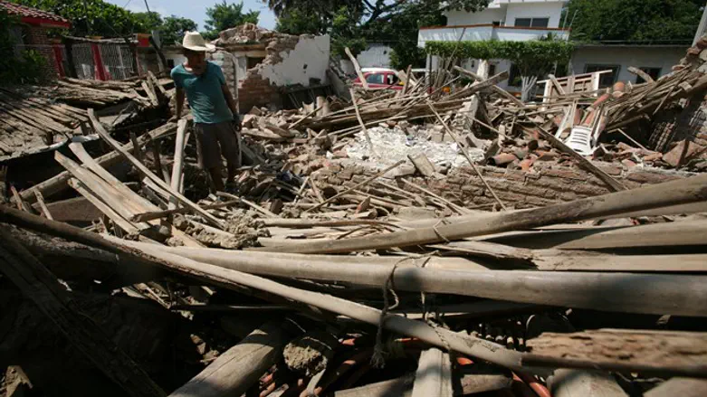 man stands in ruins of house following Mexico earthquake