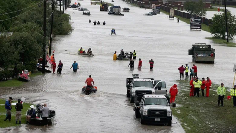 People making their way out of a neighborhood flooded by Hurricane Harvey