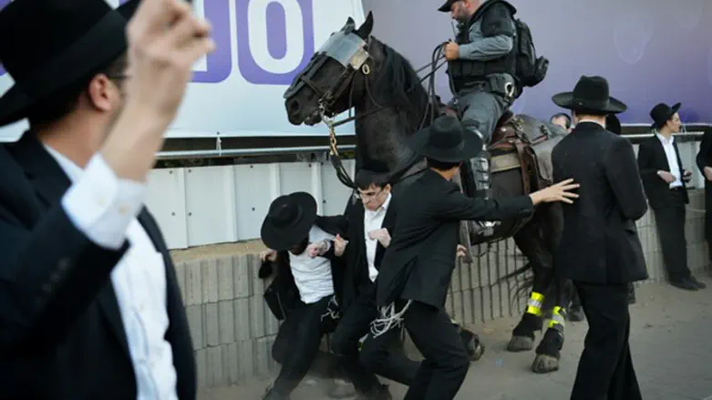 Haredi demonstrators clash with mounted officer in Bnei Brak