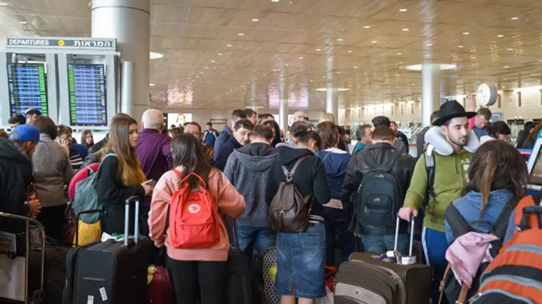 Passengers wait in line at Ben Gurion Airport