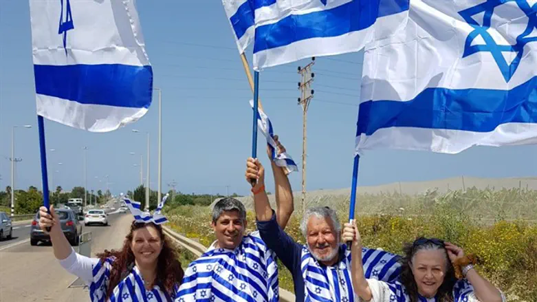Avi Farhan and family wave Israeli flags