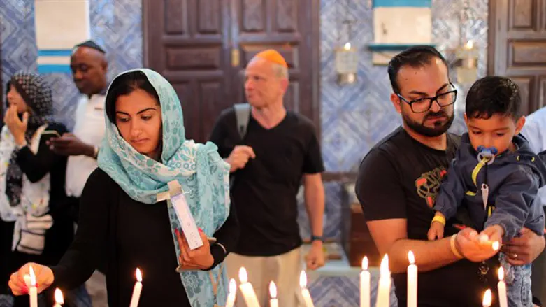 Worshippers light candles inside Ghriba synagogue in Djerba