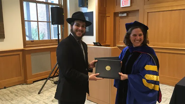 Jacob Niebloom receives his two bachelor's degrees from Dean Wendi Heinzelman