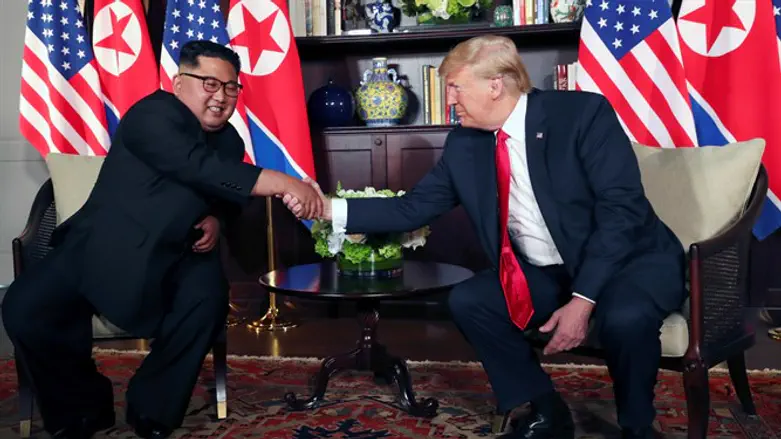 Donald Trump shakes hands with Kim Jong Un in Singapore