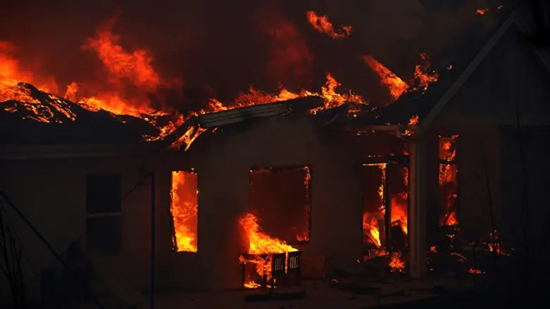 Building engulfed in flames during the Camp Fire in Paradise, California