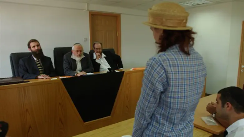 A woman converts to Judaism in front of a rabbinic court in Jerusalem