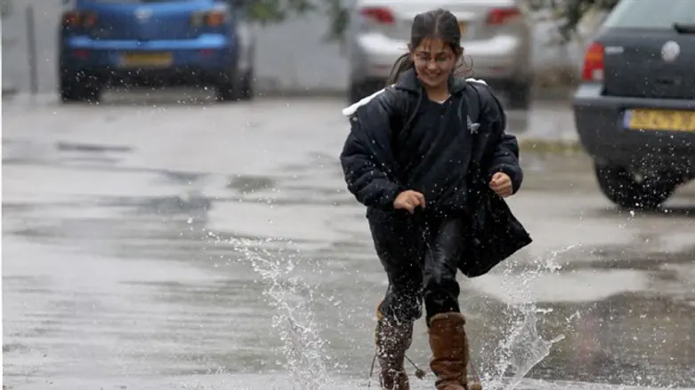 Girl splashes in a puddle