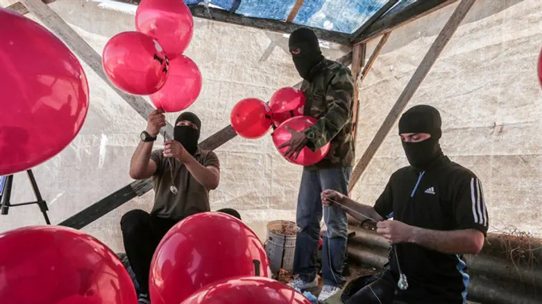 Hamas terrorists prepare incendiary balloons