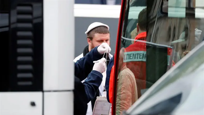Jewish man is escorted from from the site of a shooting in Halle