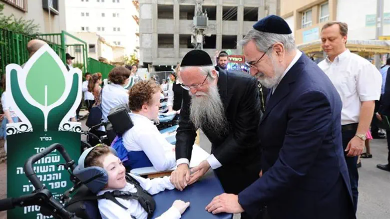 Rabbi Yehuda Marmostein and Rabbi Lord Jonathan Sacks greet ALEH residentss
