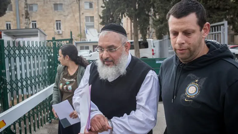 Police escort Rabbi Aharon Ramati for court hearing