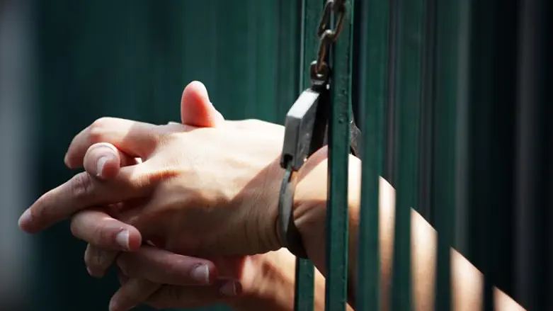 Hands of prisoner in jail