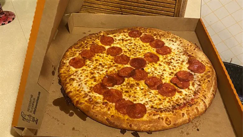 Pizza with pepperonis arranged in the shape of a swastika