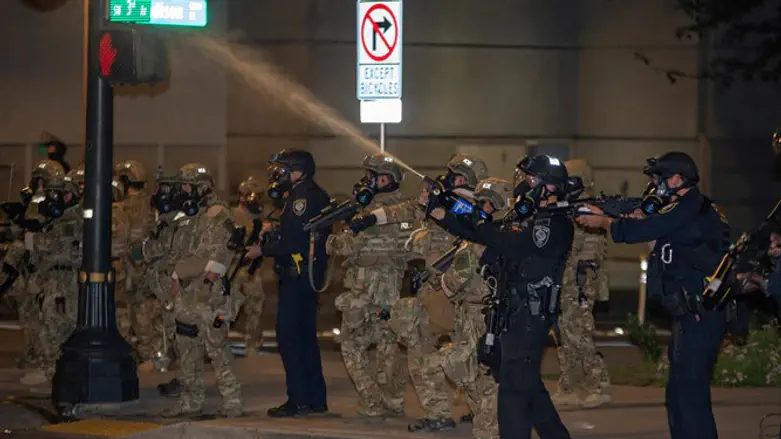 Federal law enforcement officers work to control protest in Portland, Oregon, in