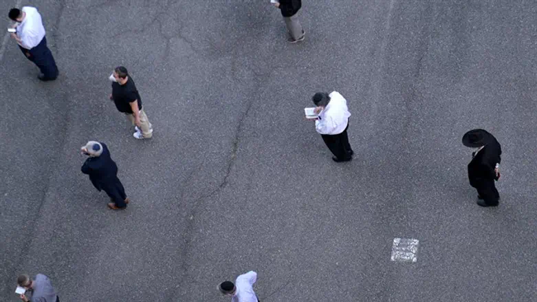 Jewish men hold socially distanced prayers at a basketball court on NYC's Lower East Side
